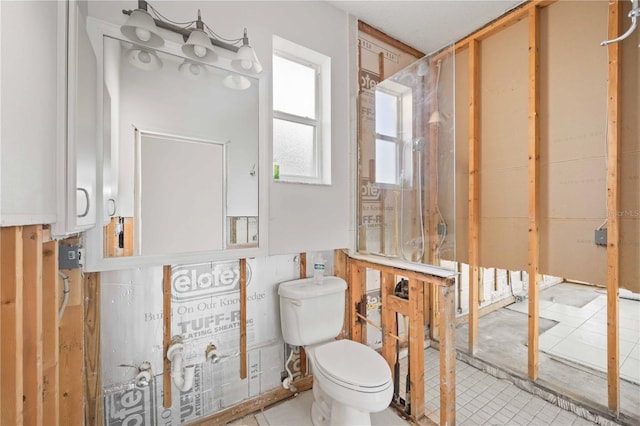 bathroom with toilet and tile patterned floors