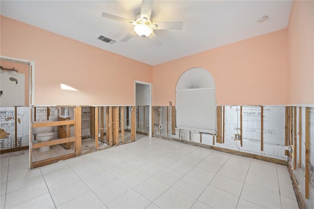 empty room with ceiling fan and light tile patterned floors