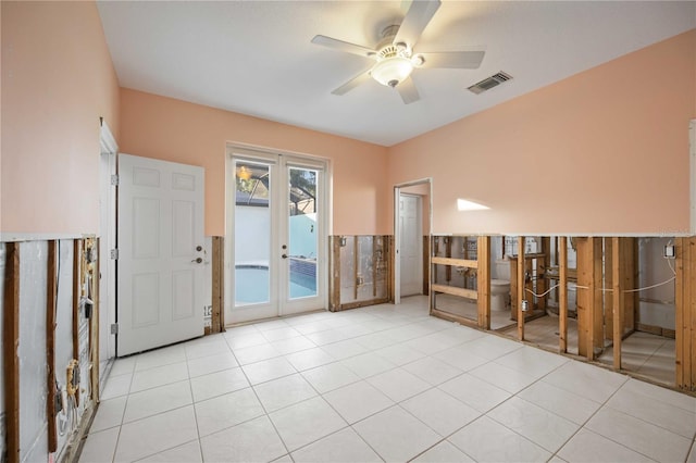 empty room featuring ceiling fan and light tile patterned flooring