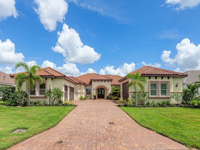 mediterranean / spanish house featuring a front lawn