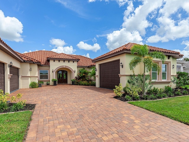 mediterranean / spanish-style home with a garage