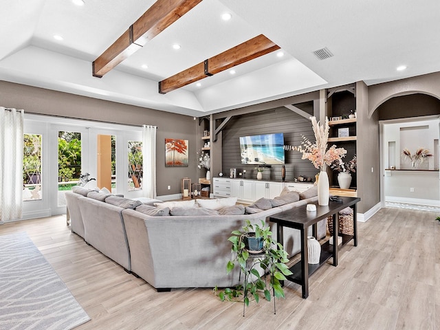 living room with light hardwood / wood-style flooring and vaulted ceiling