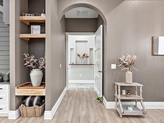 hallway with wood-type flooring