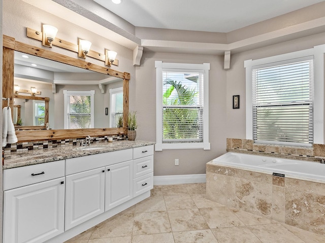 bathroom with vanity, tiled tub, tile patterned floors, and decorative backsplash