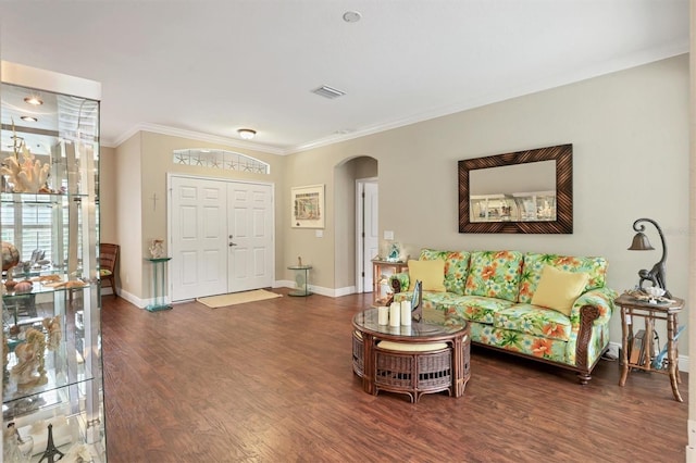 living room with dark hardwood / wood-style flooring and crown molding