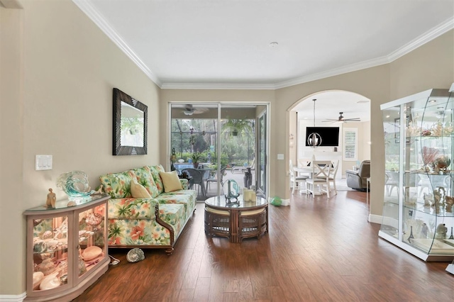 living room with ceiling fan, ornamental molding, and dark hardwood / wood-style flooring