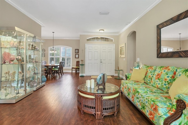 living room with dark hardwood / wood-style flooring and crown molding