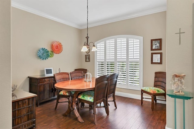 dining space with ornamental molding, dark wood-type flooring, and a chandelier