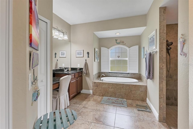 bathroom featuring tile patterned flooring, vanity, and shower with separate bathtub