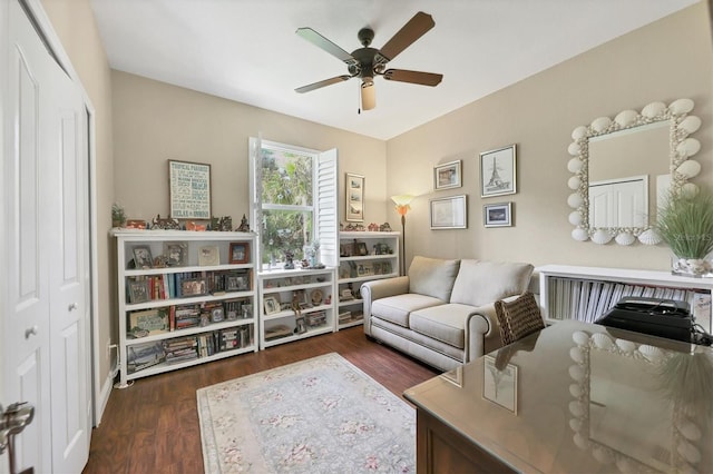 sitting room featuring ceiling fan and dark hardwood / wood-style floors