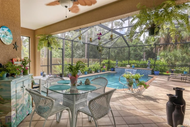 exterior space with glass enclosure, a patio area, and ceiling fan