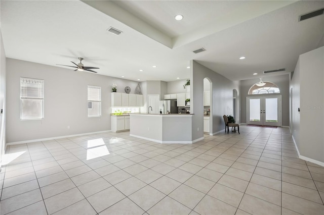 interior space with white cabinets, light tile patterned floors, ceiling fan, stainless steel refrigerator with ice dispenser, and french doors