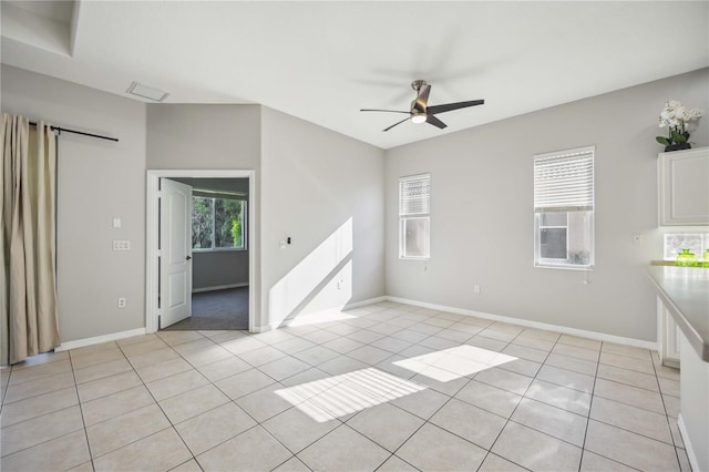 empty room featuring light tile patterned floors and ceiling fan