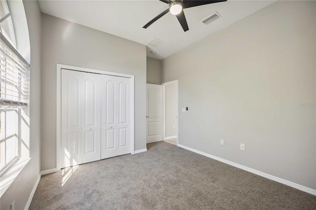 unfurnished bedroom with ceiling fan, carpet floors, and a closet