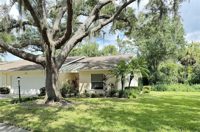 view of front of property with a front yard and a garage