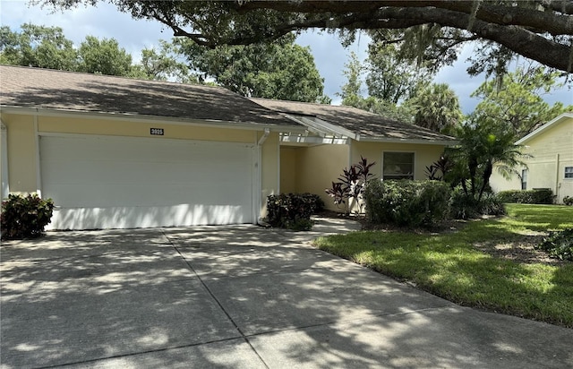 single story home with a garage and a front yard