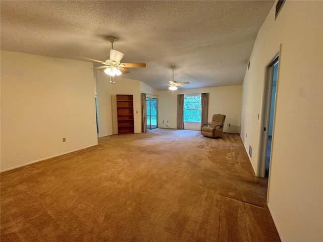 carpeted empty room with ceiling fan, a textured ceiling, and lofted ceiling