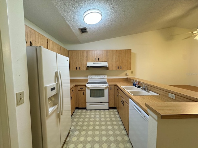 kitchen with white appliances, a textured ceiling, vaulted ceiling, and sink