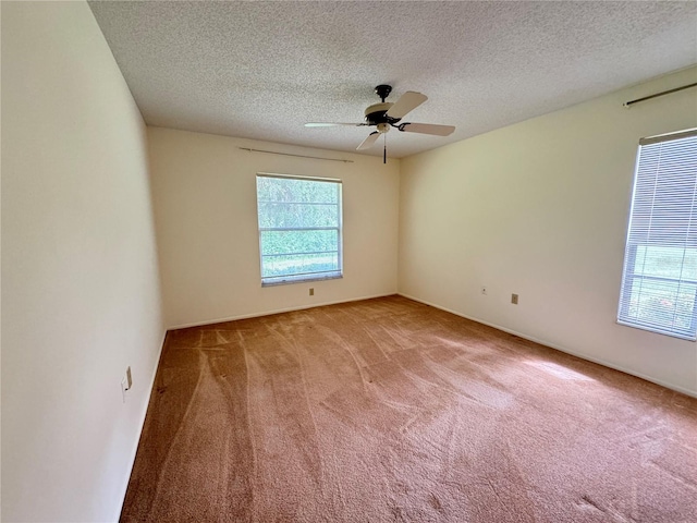 carpeted spare room with ceiling fan and a textured ceiling