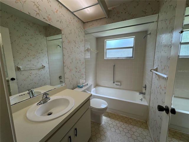 full bathroom with vanity, tiled shower / bath combo, toilet, and tile patterned flooring