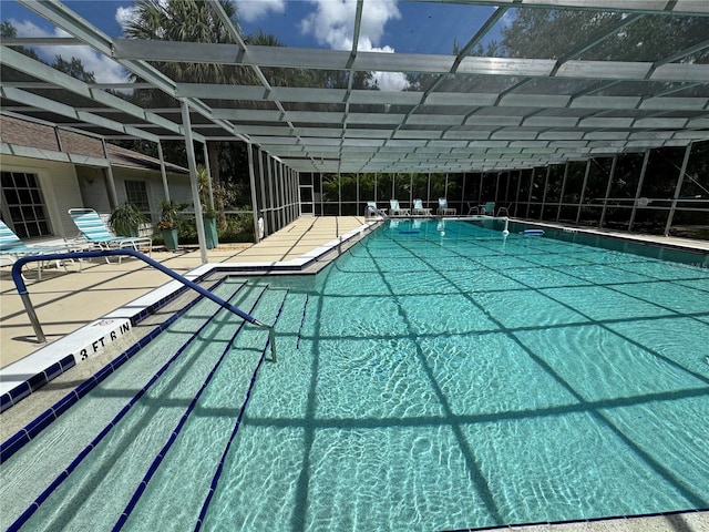 view of swimming pool featuring a lanai