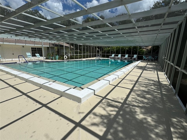 view of pool with a lanai and a patio