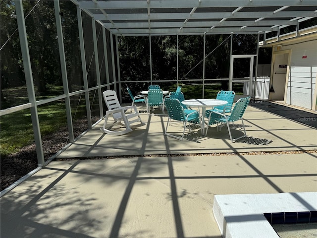 view of patio featuring a lanai