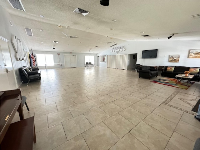 living room with lofted ceiling and a textured ceiling