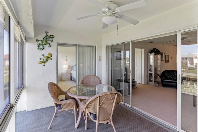 sunroom featuring a ceiling fan