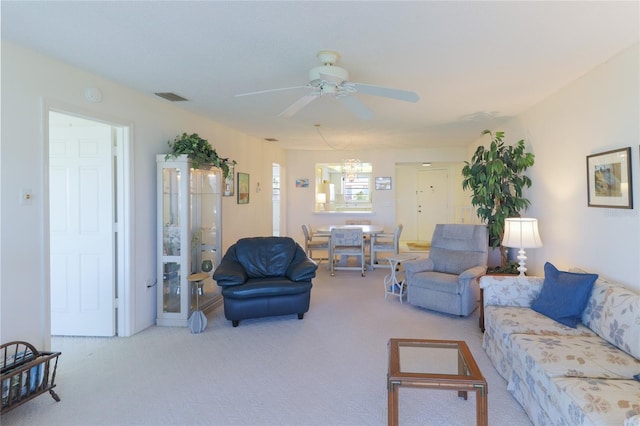 carpeted living area with a ceiling fan and visible vents