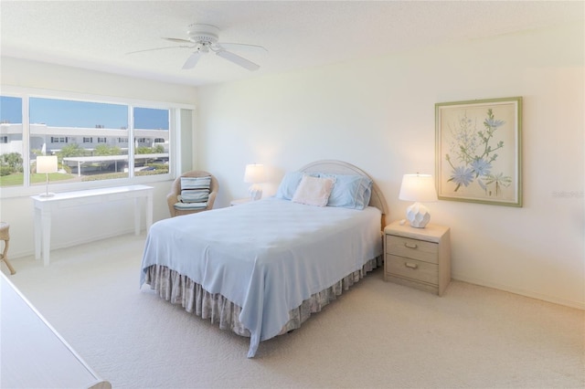 bedroom with a ceiling fan, carpet flooring, and baseboards