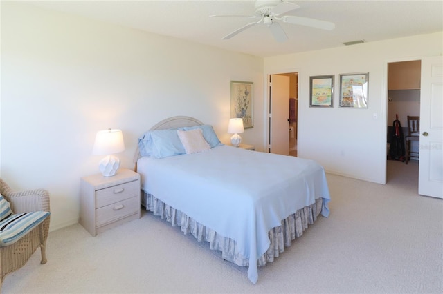 bedroom featuring light carpet, ceiling fan, visible vents, and baseboards