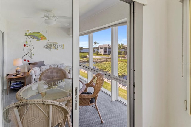 sunroom / solarium featuring a ceiling fan