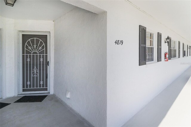 property entrance with stucco siding