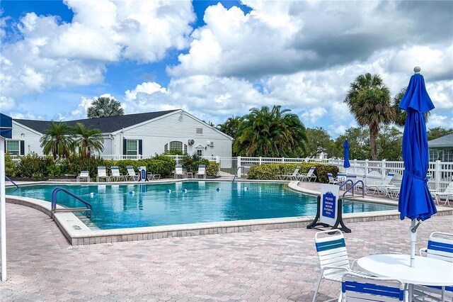 pool featuring a patio area and fence