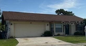 ranch-style home with a front yard and a garage