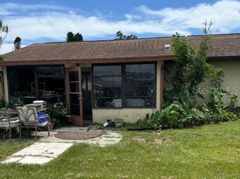 rear view of property featuring a yard