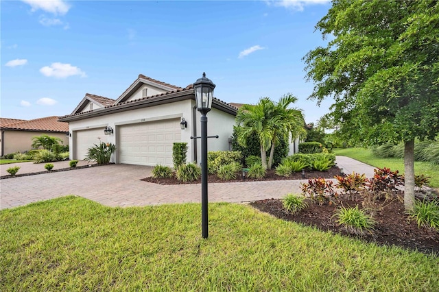 view of front of home with a garage and a front lawn