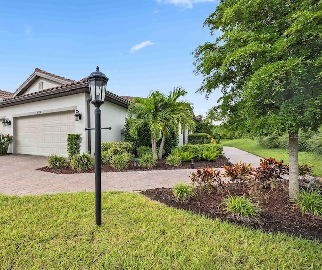 view of home's exterior with a garage and a yard