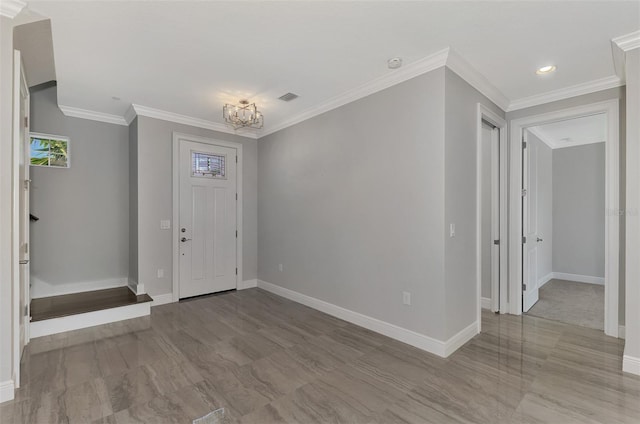 entrance foyer with crown molding and light hardwood / wood-style flooring