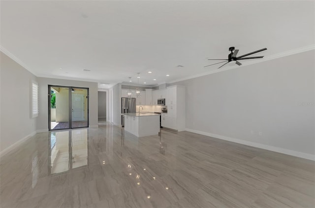 unfurnished living room with ornamental molding, sink, and ceiling fan