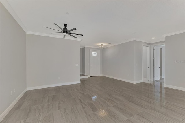 empty room with ornamental molding, light hardwood / wood-style flooring, and ceiling fan