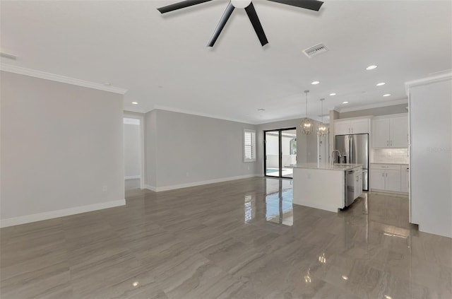 unfurnished living room featuring visible vents, baseboards, a ceiling fan, and ornamental molding