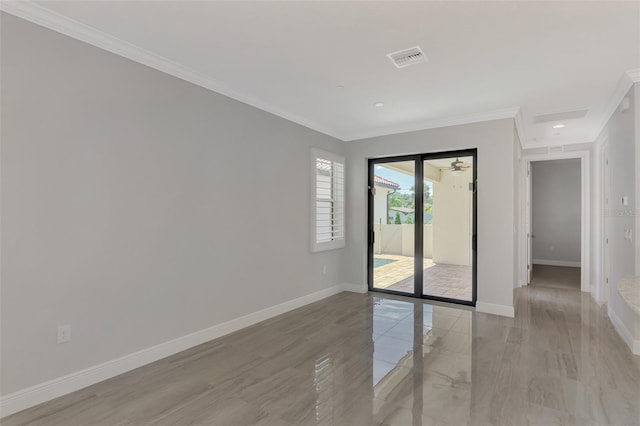 unfurnished room featuring marble finish floor, visible vents, baseboards, and ornamental molding