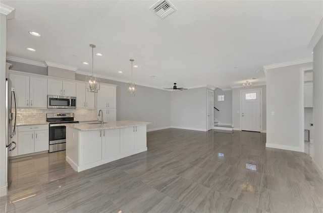 kitchen with light stone countertops, a center island with sink, stainless steel appliances, white cabinetry, and ceiling fan