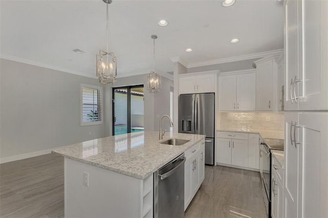 kitchen with light hardwood / wood-style floors, an island with sink, stainless steel appliances, light stone counters, and white cabinets