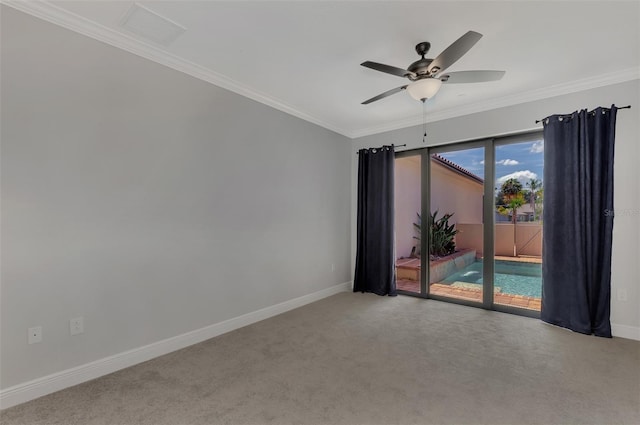 unfurnished room with crown molding, carpet flooring, and ceiling fan