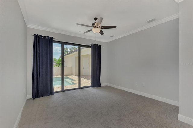 carpeted spare room featuring ceiling fan and ornamental molding