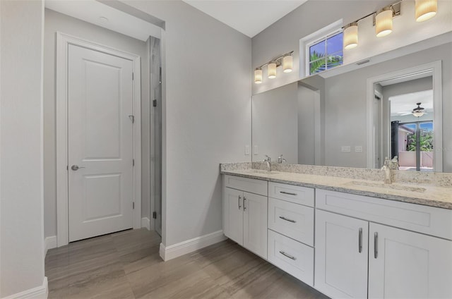 bathroom featuring ceiling fan, hardwood / wood-style flooring, and vanity