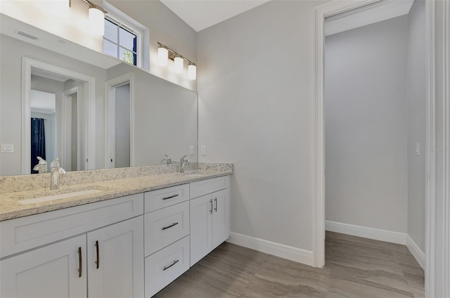 bathroom with hardwood / wood-style floors and vanity